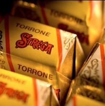 Load image into Gallery viewer, Close-up of Torrone Strega candy boxes with a blurred background
