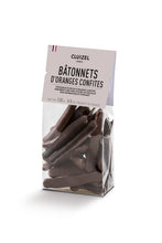 Load image into Gallery viewer, A clear plastic bag of Cluizel Bâtonnets D'Oranges Confites, showing dark chocolate orange-shaped sticks inside, with a white paper header label on a white background.