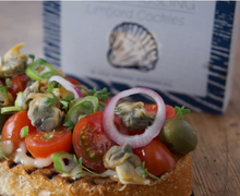 Load image into Gallery viewer, Fangst Cockles on toast with tomatoes, mayo, onions, and capers.