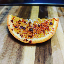 Load image into Gallery viewer, Silk Chili Pepper Flakes on Orange Wedge, on Cutting Board