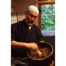 Load image into Gallery viewer, Yamatsu Tsujita mixing shichimi togarashi.