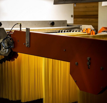 Load image into Gallery viewer, Spaghetti being made and hung in factory