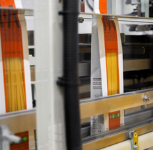 Load image into Gallery viewer, bags of spaghetti pasta being filled on the production line