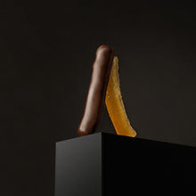 Load image into Gallery viewer, Cluizel Candied OJ Peel Dipped in Dark Chocolate, Close-Up, With Black Background
