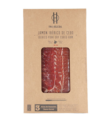Kraft envelope with clear window showing sliced Iberico cured ham from Finca Helechal by Fermin, 24 mos cured (Spain).