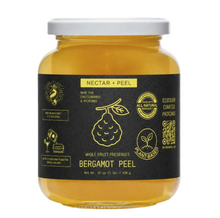 Load image into Gallery viewer, A jar of Bergamot Peel Nectar + Peel whole fruit preserves by Discover Curated Patisons, featuring a black label with yellow text and illustrations on a white background.
