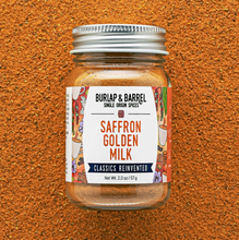 Load image into Gallery viewer, A jar of Burlap &amp; Barrel Saffron Golden Milk spices, featuring a white label with orange and navy text, set against a textured orange-brown background.
