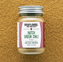 Load image into Gallery viewer, A jar of Burlap &amp; Barrel Hatch Green Chili Powder spice set against a textured tan background.
