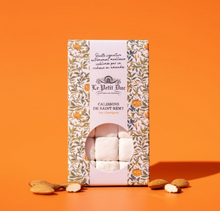 Load image into Gallery viewer, Le Petit Bouchon Calissons de Saint Rémy almond chocolates in a decorative floral-patterned box, displayed on a vibrant orange background with a few almonds scattered at the base.

