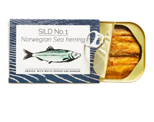 Load image into Gallery viewer, Open tin of opened Fangst Faroe Islands salmon with sea buckthorn and lemon verbena.
