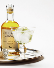 Load image into Gallery viewer, Bottle of Gris-Gris cocktail mixer with a glass of cocktail on a tray
