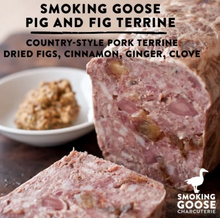 Load image into Gallery viewer, Smoked goose pig and fig terrine sliced to show the marbled pink meat with fig pieces, with a small bowl of topping in the background. Large text at the top reads 'SMOKING GOOSE PIG AND FIG TERRINE' and 'COUNTRY-STYLE PORK TERRINE DRIED FIGS, CINNAMON, GINGER, CLOVE.
