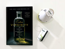 Load image into Gallery viewer, Book cover of Tom Mueller&#39;s Extra Virginity:  The Sublime and Scandalous World of Olive Oil, Along a Bottle and Label of De Carlo Olive Oil
