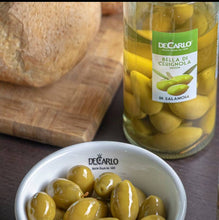 Load image into Gallery viewer, Open Jar Alongside Bowl of De Carlo Cerignola Whole Green Olives, Along Side a Loaf of Country Bread on Cutting Board.
