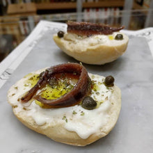 Load image into Gallery viewer, Salted capers on roasted roll, with white creamy cheese, olive oil and an anchovy fillet.
