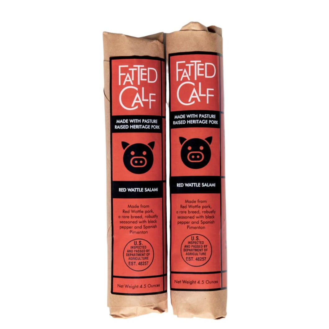 Two kraft wrapped, with red and black label, Fatted Calf artisan Red Wattle salami (Napa, California).