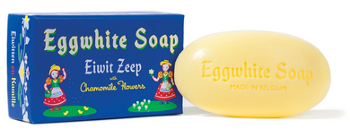 Pretty Blue Box with Swiss Girls in colorful dresses on the left and right side.  Oval embossed bar of soap next to box.  White background.
