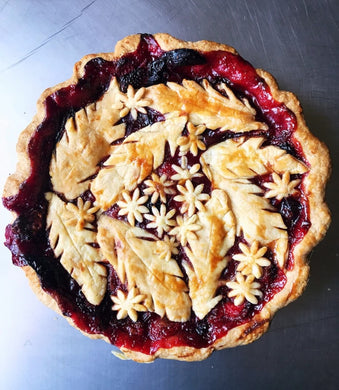 beautiful berry pie with cut out leaf and flower crust