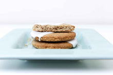 Load image into Gallery viewer, Stack of three white iced teff cookies, on white square plate, on white background.
