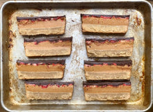 Load image into Gallery viewer, Layered dessert bars on sheet pan, made with teff flour.pe
