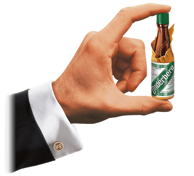 Underberg mini bottle in man's hand.